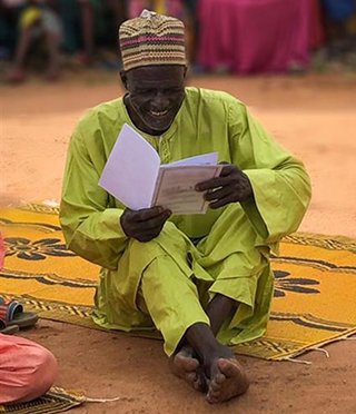 photo of man reading Bible