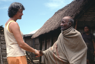 photo of woman shaking hands with man