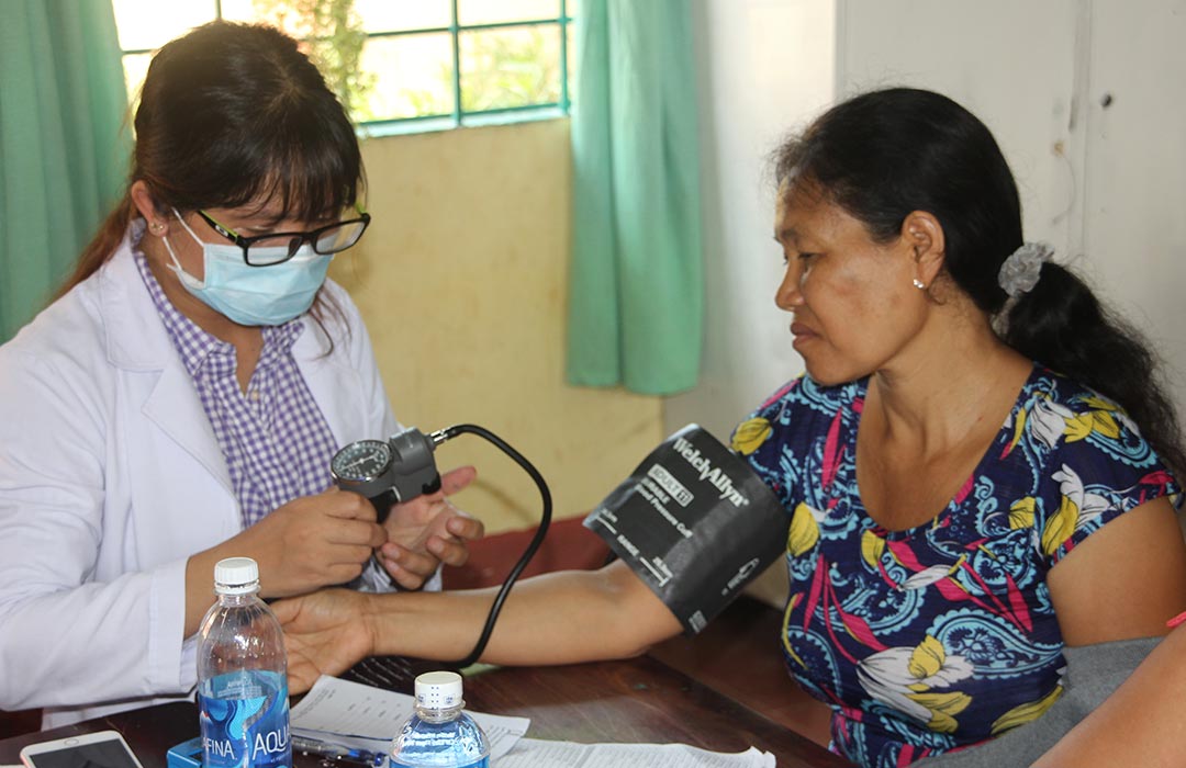 photo of volunteer doing blood pressure check