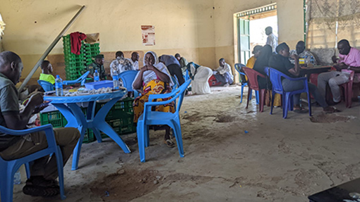 Photo of global workers on lunch break in Kenyan village