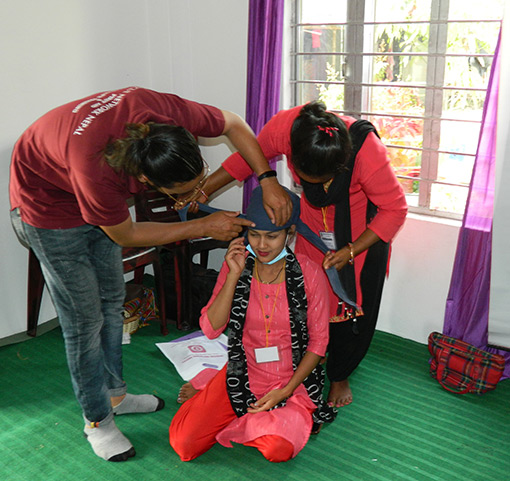 photo of first aid workers in Nepal learning a procedure for a head injury