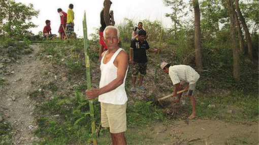 photo of Nepalese men planting bamboo