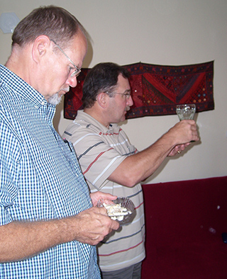 photo of two men serving communion