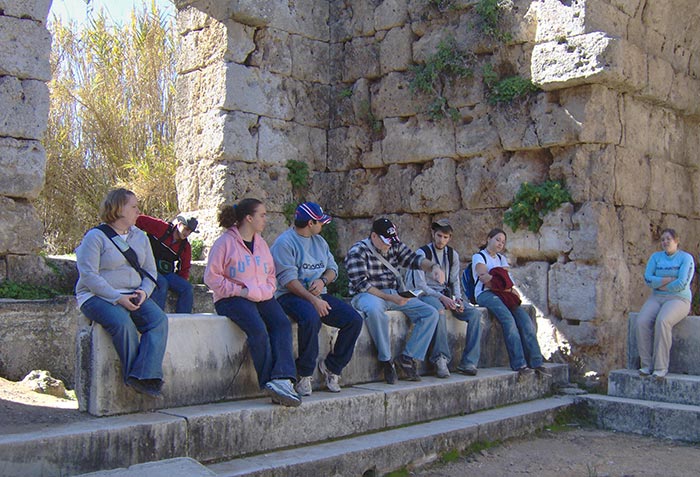 group of people sitting in ruins in Turkey