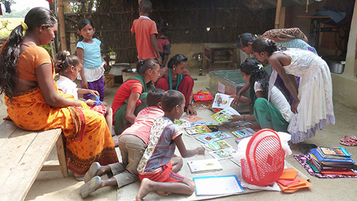 group of children reading books in village in Nepal