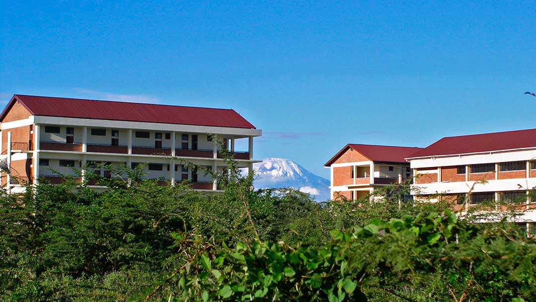photo of university buildings in Tanzania with Mt. Kilimanjaro in background