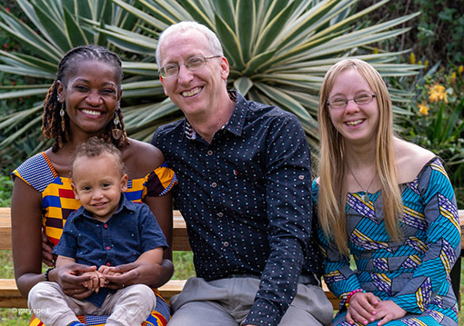 Photo of American man and daughter with Tanzanian wife and son