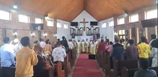 people standing in worship service in church 