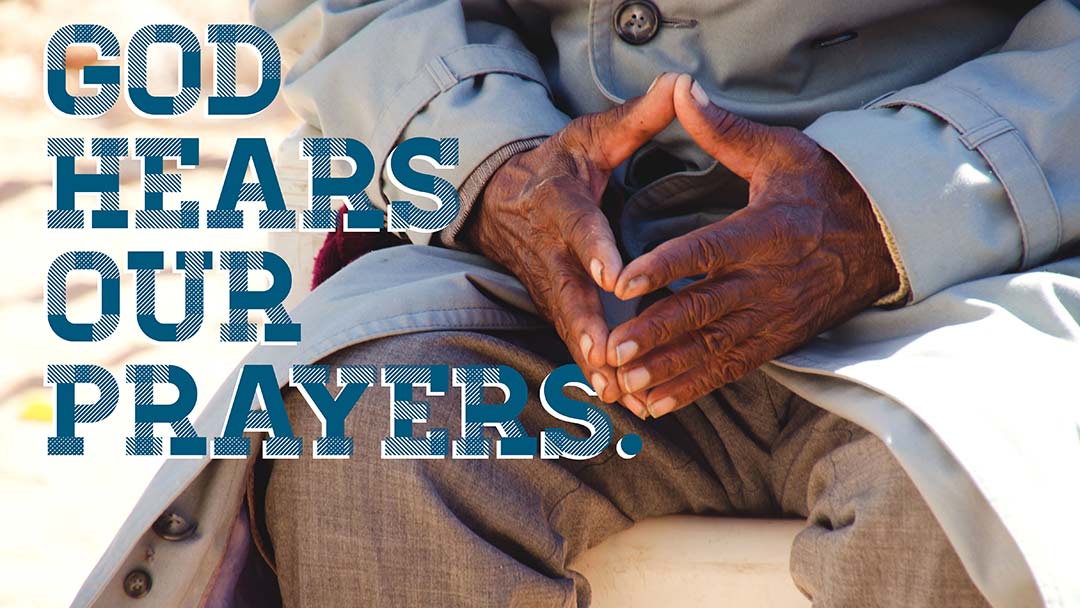 man sitting with hands folded in prayer and text GOD HEARS OUR PRAUERS