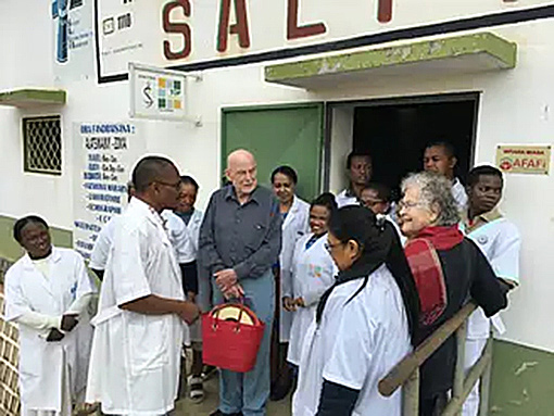 Madagascar doctors in white coats with American doctor in front of clinic