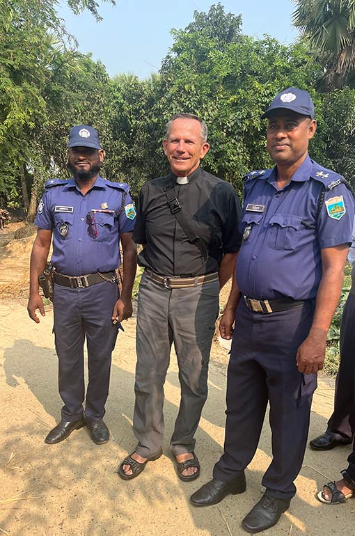 American pastor posing for photo with two Bangladesh policemen