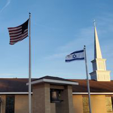 flags and steeple above church building