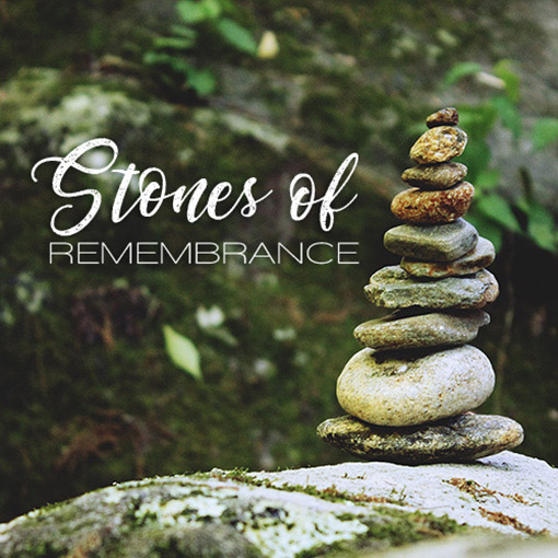 stack of stones against leafy background with words Stones of Remembrance