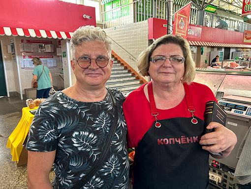 man and woman standing in marketplace