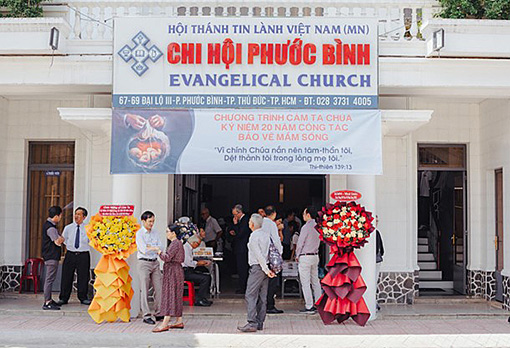 people in front of Vietnamese church