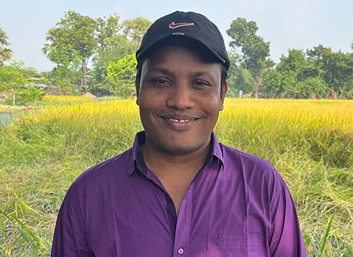 man wearing baseball cap and purple shirt