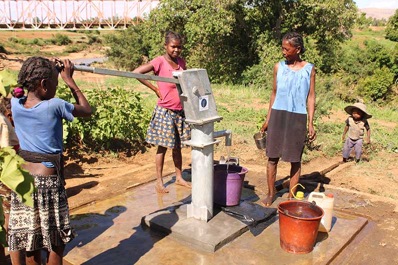 villagers drawing water from a new well