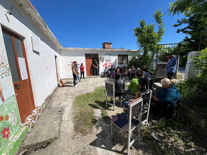 group of youth and leaders meeting outside home