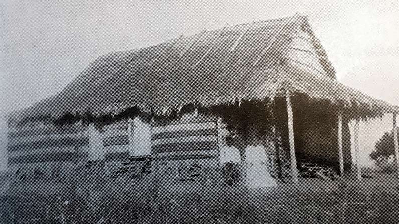 vintage photo of missionary family by primitive home
