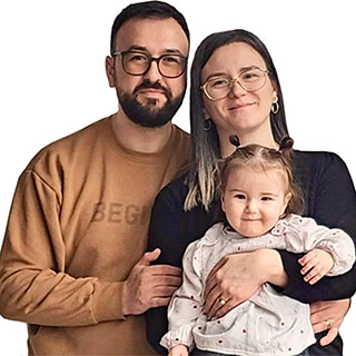 man with woman holding little girls