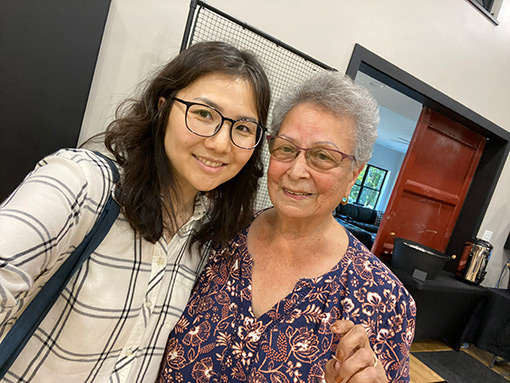 two women, one younger with dark hair the other with gray hair, posing for selfie