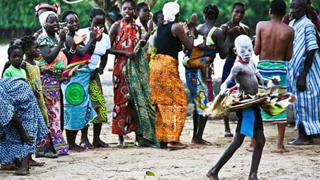 witch doctor dancing in from of people in Madagascar