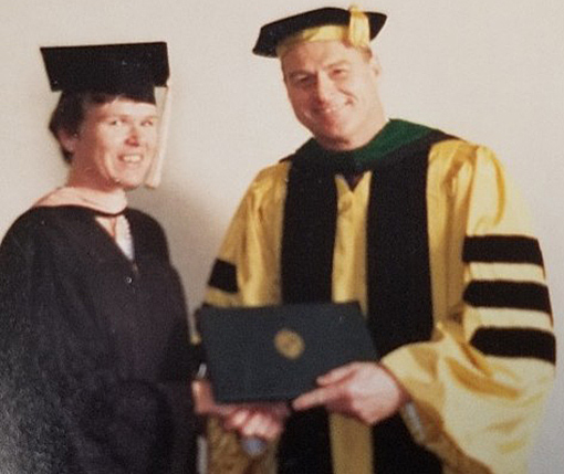 woman receiving diploma