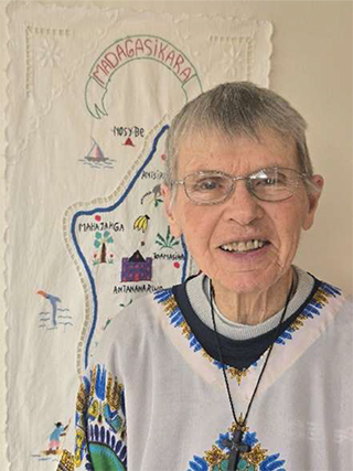 older woman with short gray hair wearing glasses