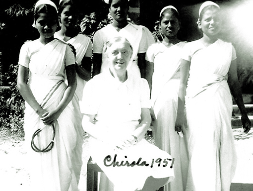 vintage photo of woman missionary in India with nursing students