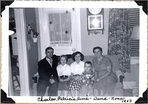 vintage photo of family sitting on sofa in living room