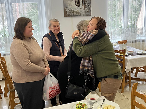 women hugging after attending a conference