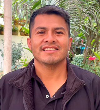 man with dark hair wearing dark shirt