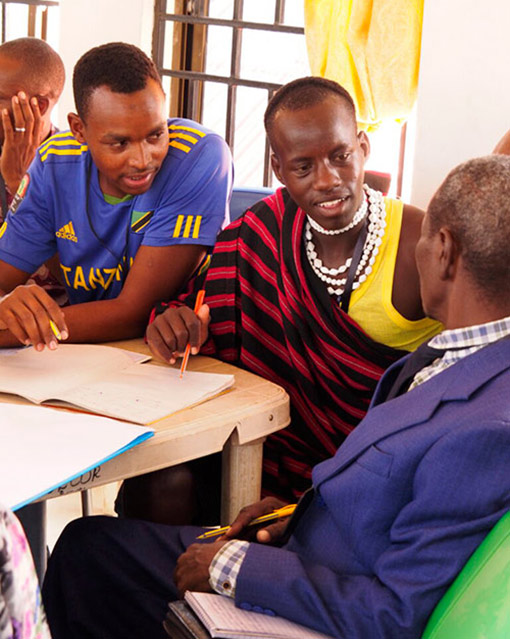 3 men in Tanzania discussing project
