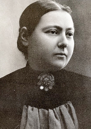 vintage photo of woman wearing dark dress with brooch