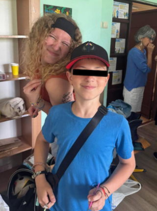 boy wearing blue shirt standing in front of teenage girl