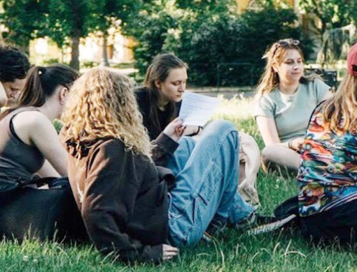 group of teenage girls sitting on lawn