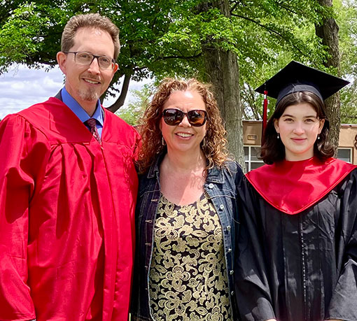 pastor and wife with high school graduate