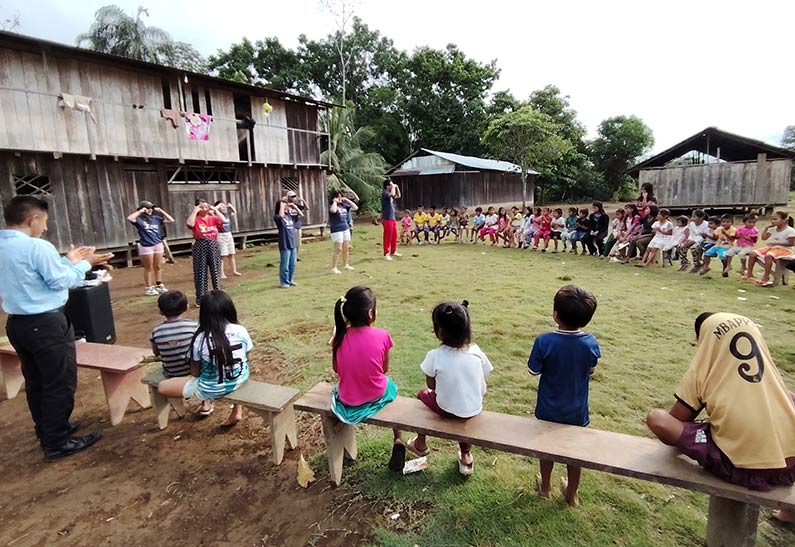 Children and adults participating in an activity in a small village in Indonesia